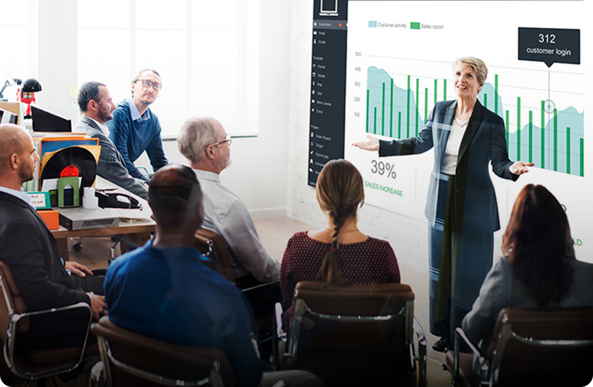 An educator presenting to a group during a training session
